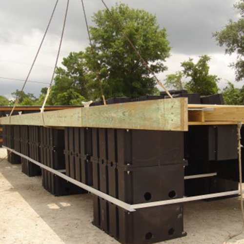 Wave attenuator floats mounted to wooden dock frame