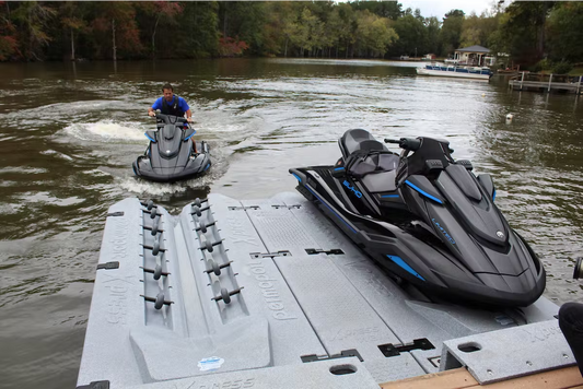 Photo of a person docking their personal watercraft onto a permaport xpress floating dock. This dock is attached to a floating dock and is meant to keep any pwcs out of the water for storage.