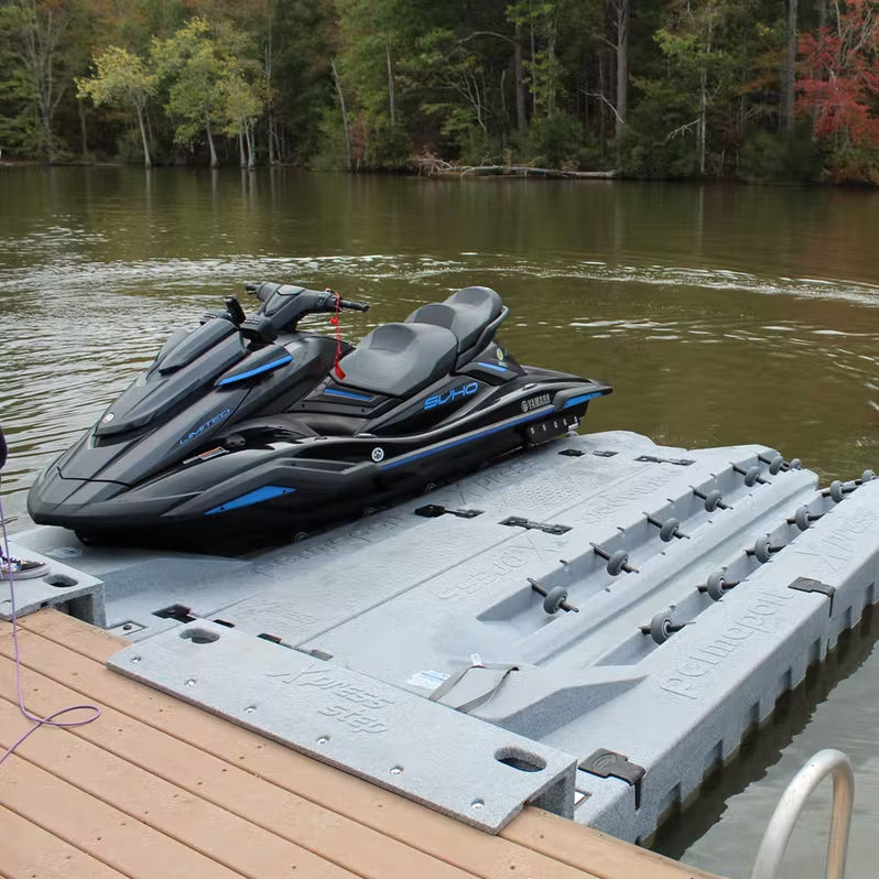 Picture of two Permaport Xpress ports joined together by the Xpress walk and mounted to the floating dock with the Xpress step. One port has a personal water craft docked on top.