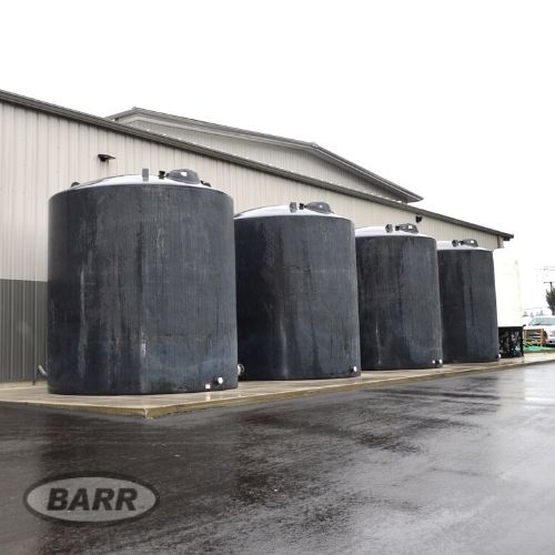Four high capacity black potable water tanks installed for rainwater harvesting