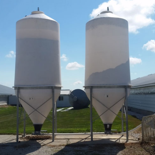 Two Cone Bottom Polybins holding grain partially filled